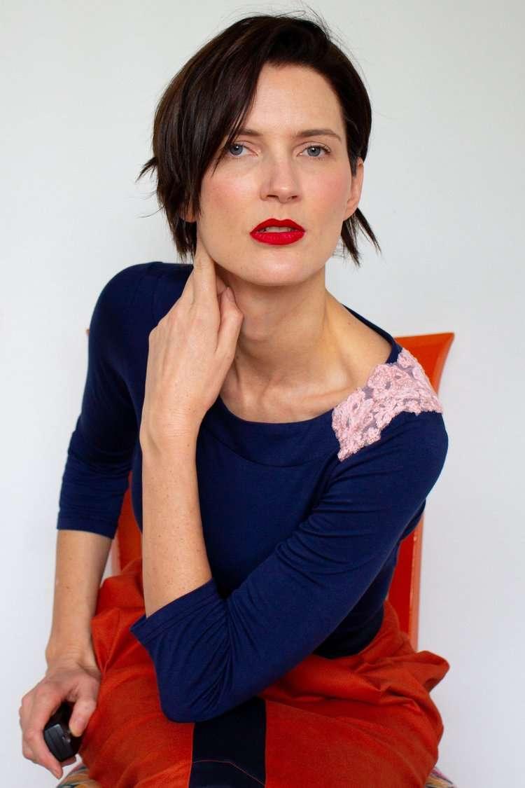 Navy top with a pink floral shoulder applique detail.