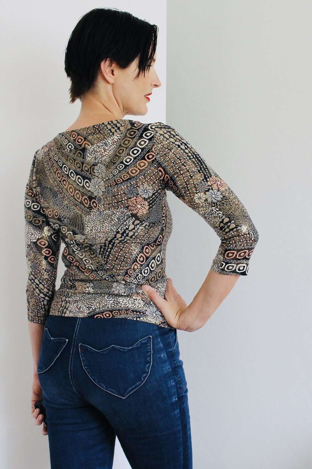 Patterned Top with 3/4 Sleeves - Intricately patterned top featuring an earthy, abstract design with circular and linear motifs in neutral and warm tones.