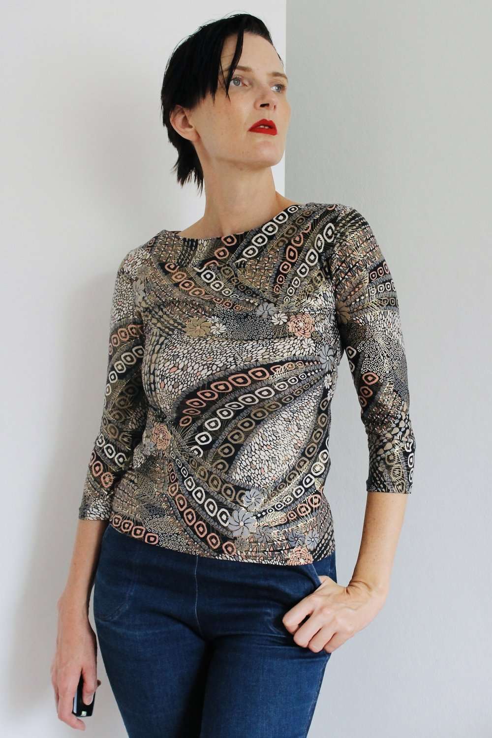 Patterned Top with 3/4 Sleeves - Intricately patterned top featuring an earthy, abstract design with circular and linear motifs in neutral and warm tones.