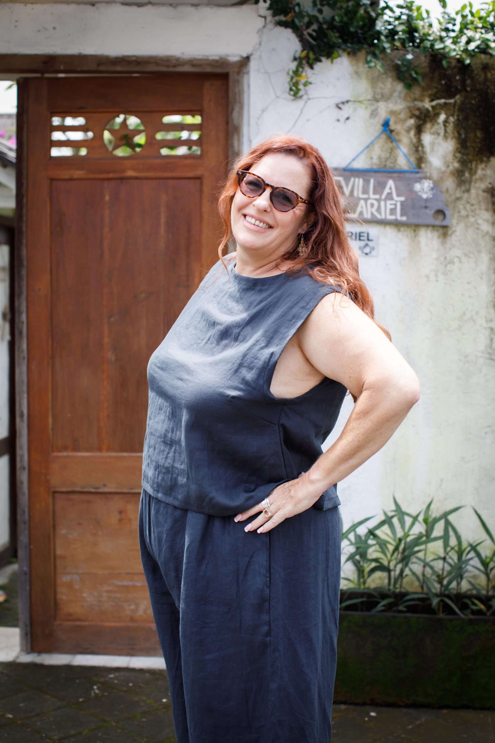 indigo linen top middle-aged woman showing left side of sleeveless top